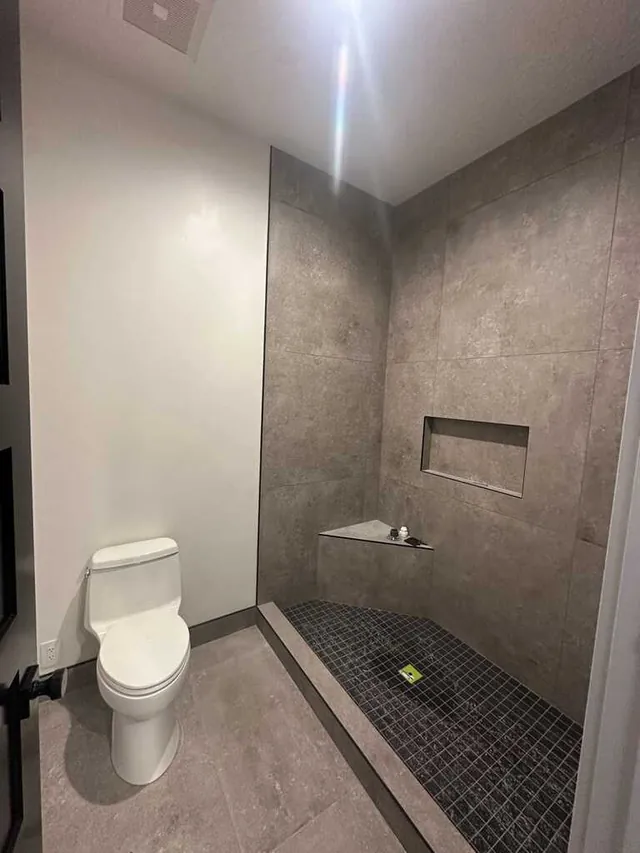 Modern bathroom with tiled walk-in shower and fresh white paint