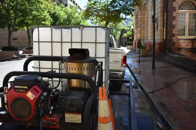 Hot-water pressure washing rig with water tank on a commercial job