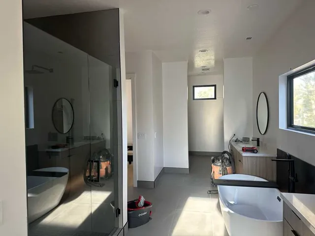 Primary bathroom with glass shower, freestanding tub, and fresh paint