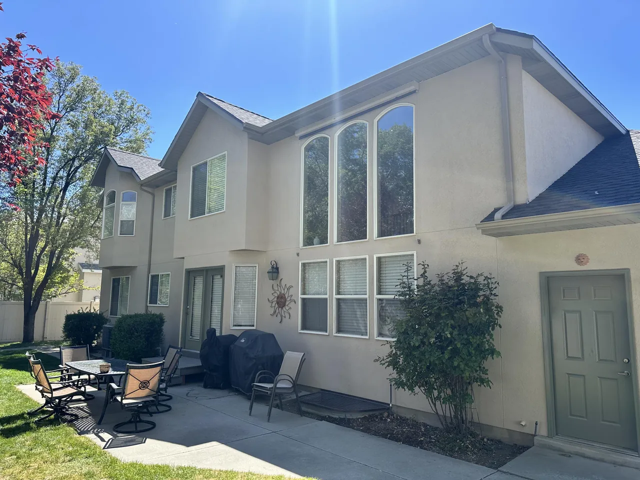 Freshly repainted two-story stucco home exterior in Sandy, UT